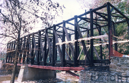 Loy's Station Covered Bridge, showing timber frame stripped of finish goods and nailers.  Note temporary bracing.