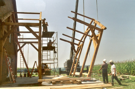 Bent assembly with purlins inserted, tipped up by crane.