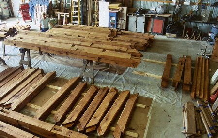 Libertytown project timber frame elements laid out in the shop after having received a preservative stain.