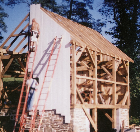 Waterhouse project being closed in with vertical siding.