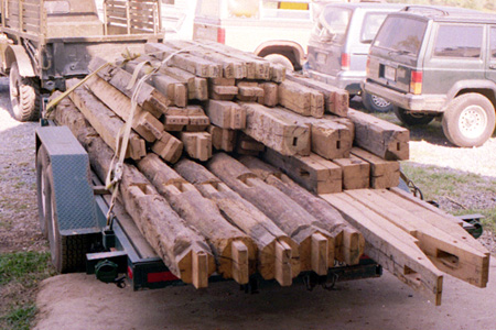 Libertytown project timber frame elements stacked for transport on trailer.