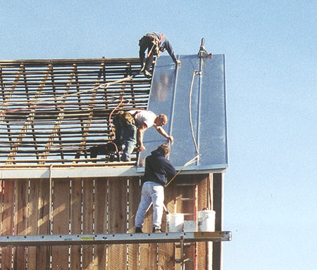 Installing new standing seamed roof pans on Dickerson barn restoration project.
