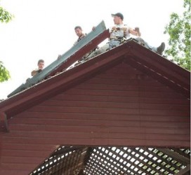 Workers remove the old roof from the Roddy Creek covered bridge. Fitzgerald's Heavy Timber Construction Inc. lead the effort, along with 20 volunteers.   (Bill Ryan photo)
