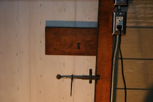 Smokehouses traditionally sored one of a family's most valuable assets -- their food -- so a stock lock secures the door against bandits and rogues.