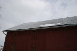 The roof is a combination of corrugated metal styles which have leaked for decades, contributing to the frame deterioration.