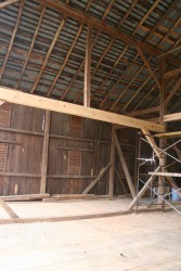 A modification for modern uses:  This heavy carrying beam allows equipment to pass deeper into the barn for hay storage.