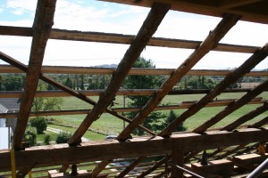 New skip sheathing over original pole rafters with the bark still intact.