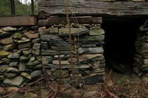 The original stone foundation, at center, is beautifully laid and remains fairly sound even though much of its mortar has been washed away.  The later porch pier, at left, was not so well constructed.