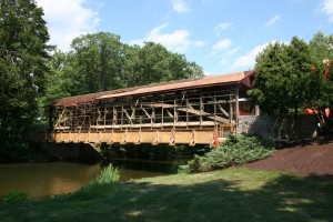Staging moved to the west side of the bridge, siding and roofing removed, and new shingles in progress.